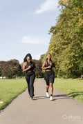 Young female friends jogging in park