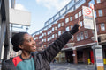 Portrait of happy young woman pointing up