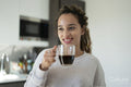 Woman drinking coffee in kitchen
