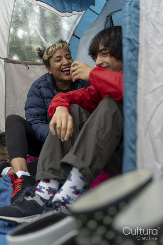 Mother and son camping in forest