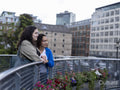 Smiling couple standing on bridge