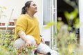 Young woman with down syndrome planting flowers in garden