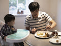 Father with baby son making moon cakes at home