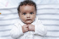 Portrait of baby girl with curly hair and brown eyes