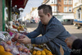 Man buying fruit in grocery store