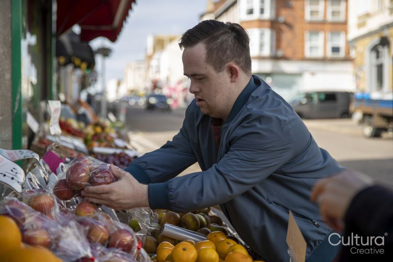 Man buying fruit in grocery store
