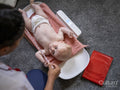 Nurse taking growth measurements of baby girl