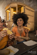 Two young women eating street food