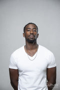 Portrait of man wearing white t-shirt and necklace