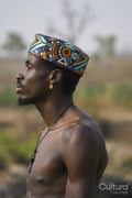 Portrait of young shirtless man wearing traditional hat