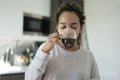 Woman drinking coffee in kitchen