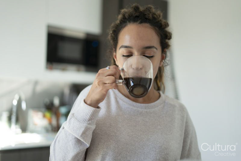 Woman drinking coffee in kitchen