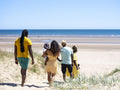 Family with baby boy going to beach