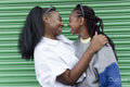 Stylish female couple smiling and hugging