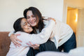 Woman hugging mother during visit in nursing home