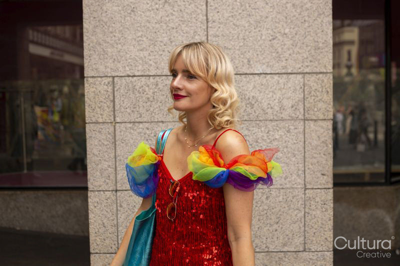 Mid adult woman wearing rainbow-flag themed decorations