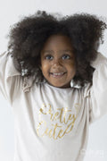 Portrait of smiling girl with hands in hair