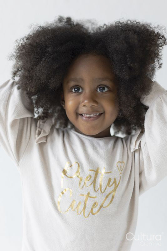 Portrait of smiling girl with hands in hair