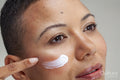 Close-up of woman applying facial cream
