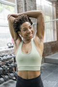 Woman stretching arms in gym before training