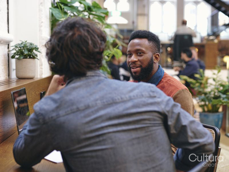 Two businessmen talking in creative studio