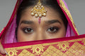 Close-up of woman wearing sari and gold jewelry
