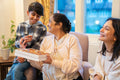 Grandma sharing pralines with grandson at nursing home during visit