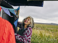 Smiling woman hanging decorations in van
