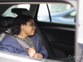 Girl fastening seat belt in car