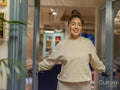 Portrait of smiling woman standing in doors at home