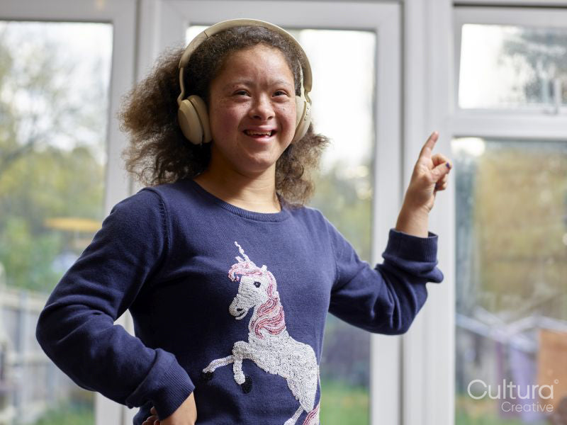 Portrait of smiling girl with Down Syndrome with headphones