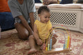 Mother playing with baby daughter at home