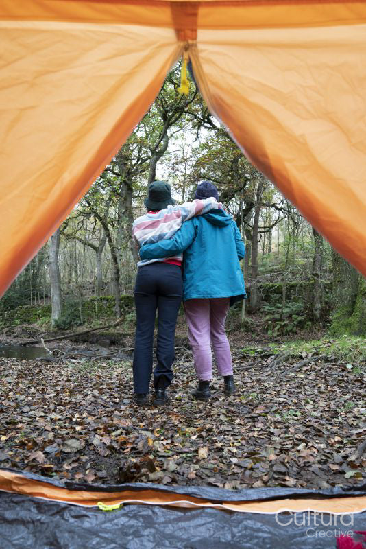 Female friends camping in forest