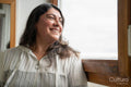 Smiling mature woman looking through window