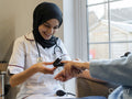 Doctor using pulse oximeter on patient