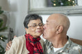 Close-up of senior man kissing woman