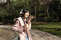 Young woman using phone in park
