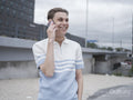 Smiling man talking on phone in city