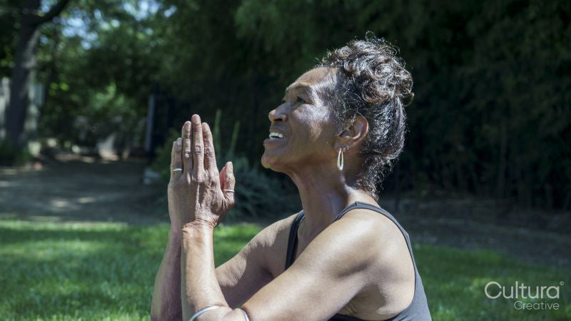 Senior woman meditating outdoors