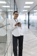 Non binary office worker standing in corridor