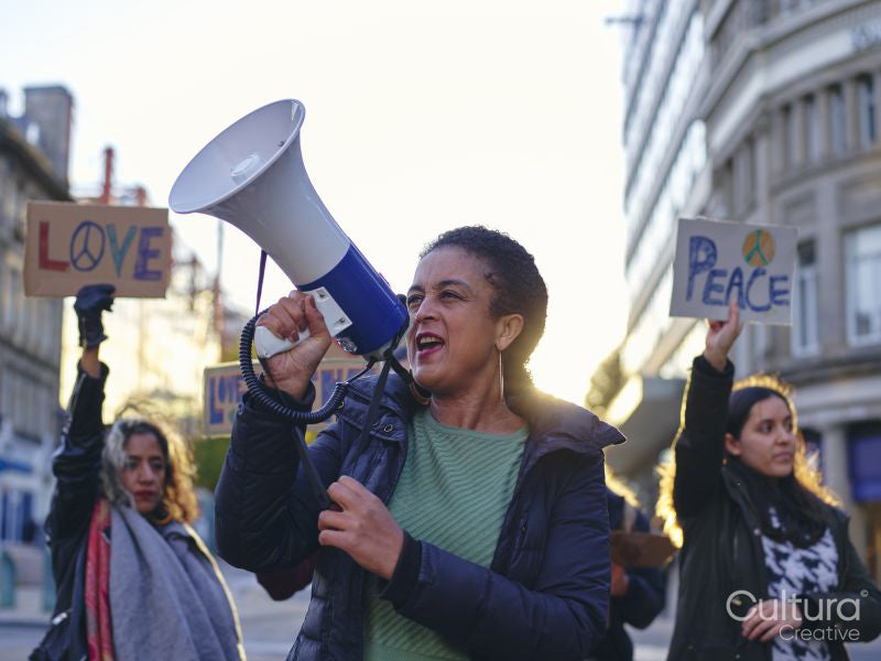 Activists holding peace signs protesting in street