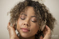 Woman with headphones listening music with eyes closed