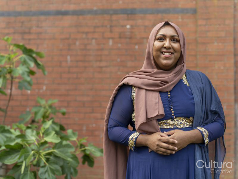 Portrait of woman wearing hijab in backyard