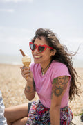Smiling woman eating ice cream on beach