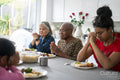 Family praying before eating dinner