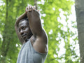 Man stretching after workout in forest