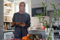 Smiling woman in hijab putting food on table