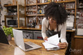 Cafe owner doing paperwork at counter