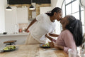 couple kissing before dinner at home