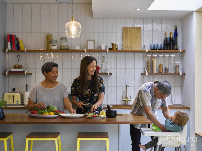 Family preparing food in kitchen